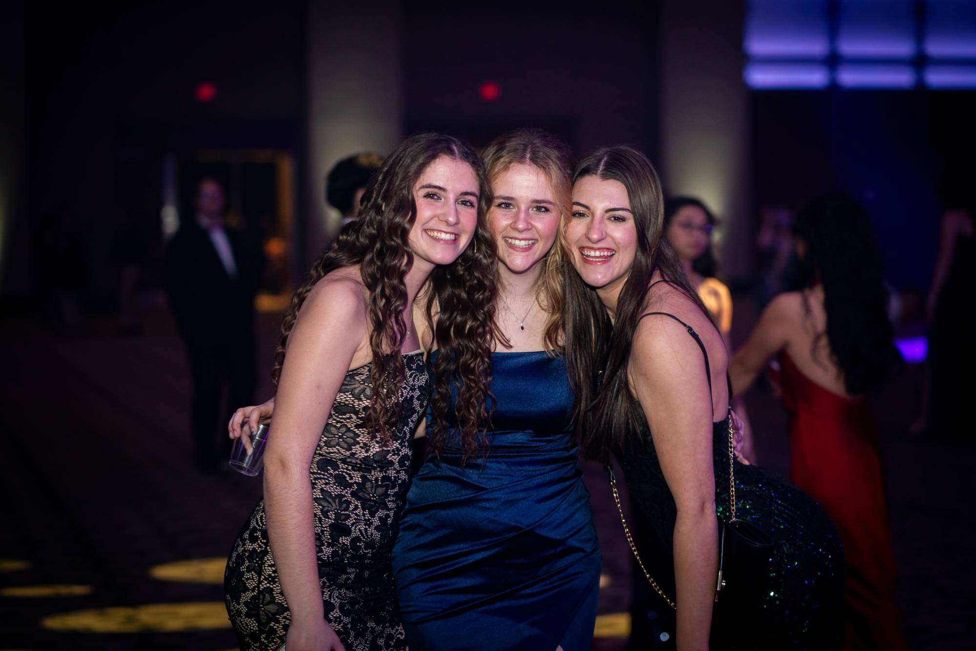 3 women smiling for photo at presidents' ball